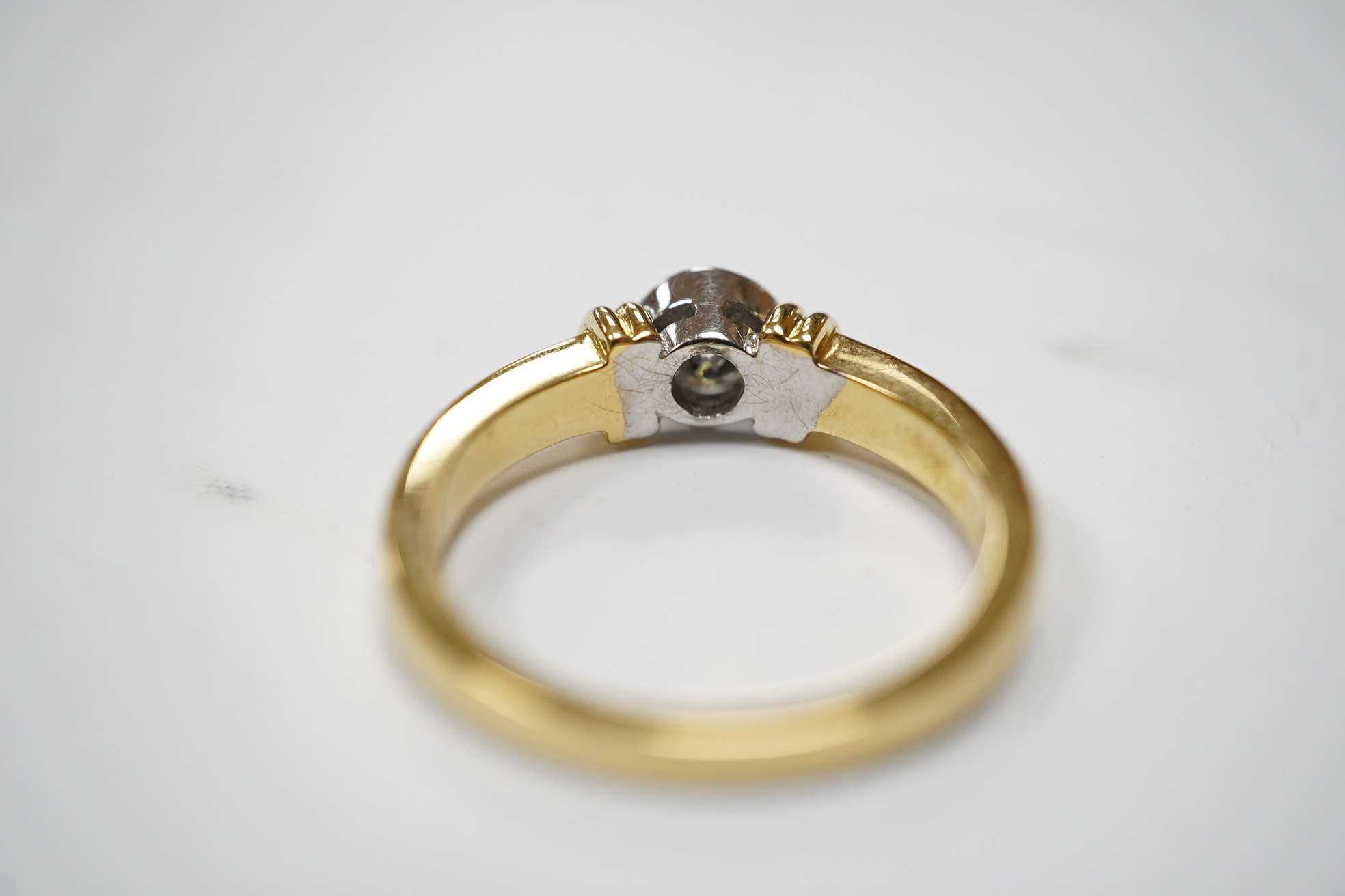 A modern 18ct gold and collet set solitaire diamond ring, size O, gross weight 5.7 grams. Condition - fair to good.